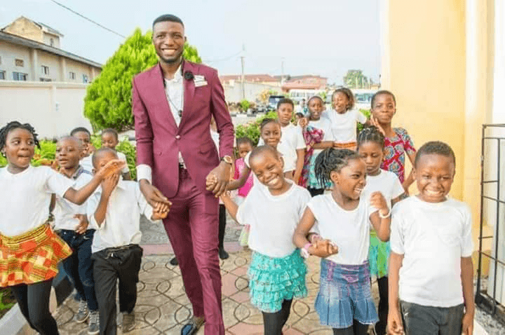 Mathew Eluwole surrounded by children from the Getup Charity Concert