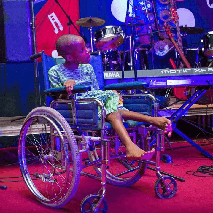A child in a wheelchair at the Getup Charity Concert, a moment of dignity and celebration